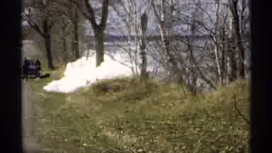 Minnesota (1970): People Walking Away From Blue Car In Snowy Wooded Area By River