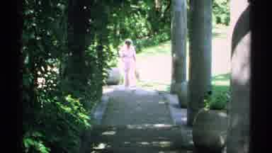 Minnesota (1970): A Lady Walks Peacefully Around The Green Tree Park With Smile On