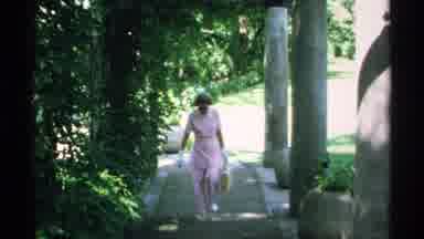 Minnesota (1970): Women Wearing Pink Walks Down The Path Then A Man In Brown Walks