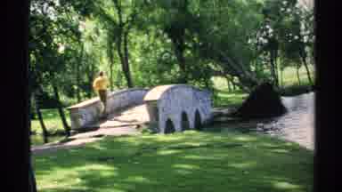 Minnesota (1970): Two Men Near A Cobblestone Bridge That Is Over A Small Stream