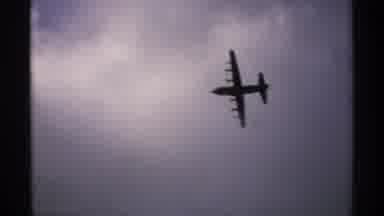 Minnesota (1970): Four Engine Propeller Plane Flies In Partly Cloudy Daytime Skies