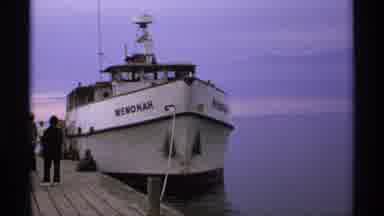 Isle Royale Michigan (1971): View Of White Boat And Island Silhouette On A Clear