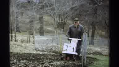 La Crosse Wisconsin (1971): Man Uses Machine To Till A Garden In A Forested