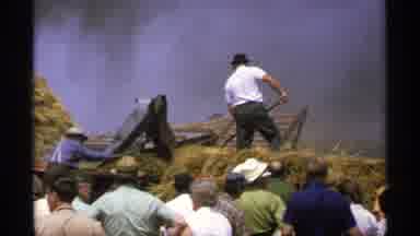 Minnesota (1971): Man Shoveling Hey Onto A Conveyor Belt As Onlookers Stand By