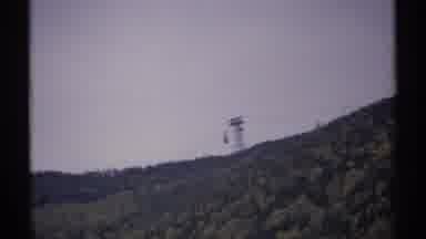New Hampshire (1971): Sky Tram Descends Down Cable Line Of Island On A Cloudy Day