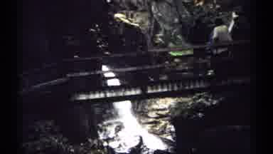 New Hampshire (1971): Several People Crossing Wood Bridge Over Roaring Waterfall