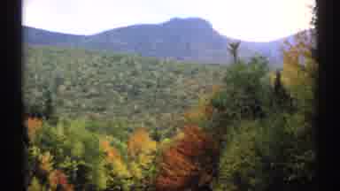 New Hampshire (1971): View Of Highway Winding Through Trees In Fall Colors Of Red
