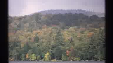 New York (1971): A Forested Hill Beside A Calm Lake And Stones On The Lake Bed
