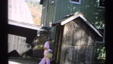 New York (1971): Woman Walking Outside Approaches Small Building But Stops Before