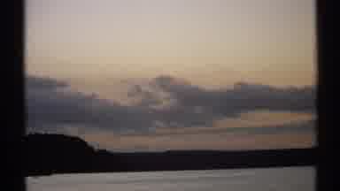 New York (1971): Clouds In The Sky With The Blue Ocean Underneath Them And Trees