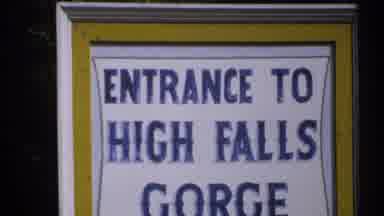 New York (1971): View Of Yellow White And Blue High Falls Gorge Sign On A Bright