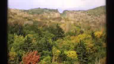 Vermont (1971): Forest Mountains Trees Cars Chalet Sky Hotel Motel Autumn Leaves