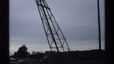 Wisconsin (1971): Damaged Gantry Leans Dangerously Over House On Land With Cloudy