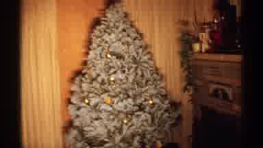 Wisconsin (1971): Snow Colored Christmas Tree With Gold Ornaments Set Up In A