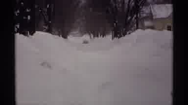 Wisconsin (1971): Car Driving Through Heavy Snow Packed Tree Lined Residential