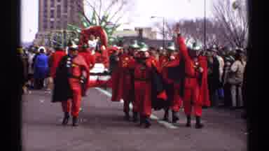 Wisconsin (1971): People Wearing Green Hats Wave To The Crowds At Parade On A