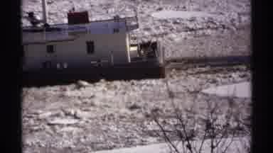 Wisconsin (1971): A Boat Makes It Way Down An Icy River To A Dock On A Cold Winter