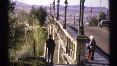 Arizona (1972): View Of Street Lantern And Person Wearing Red Pants Looking Over