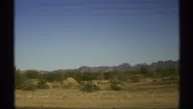 Arizona (1972): View Of Desert Shrubs And Blue Sky On A Sunny Day