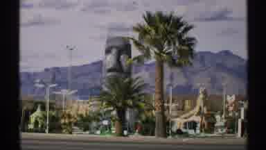 ARIZONA-1972: A Surreal View Of A Giant Stone Face And Palm Trees