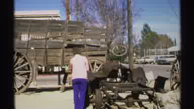 Arizona (1972): Person Wearing Blue Pants Looking Over Pile Of Wooden Scrap Pieces