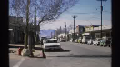 Arizona (1972): A Few People Walking Amounts The City And The White Car