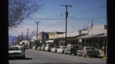 ARIZONA-1972: A Sun-Drenched Small Town Street With Classic Cars And A School Bus