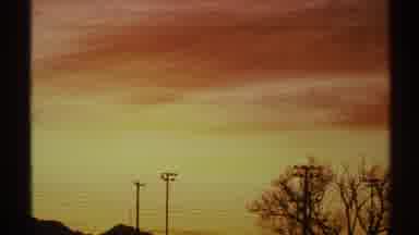 Arizona (1972): Sunset Orange And Yellow-Colored Sky With Thin Clouds Bare Trees