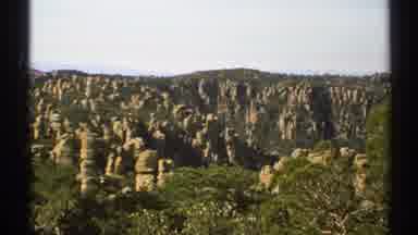 Arizona (1972): Stone Pillars In Mountains With Some Greenery Grey Sky And Purple