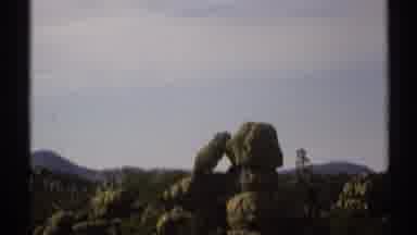 Arizona (1972): Unique Rock Formation Somewhere In The Desert With Mountains In