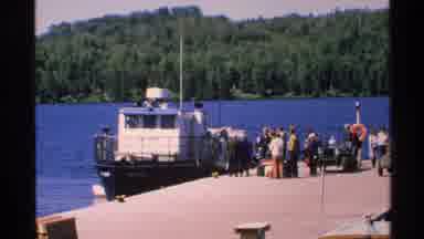 Isle Royale Michigan (1972): People Waiting To Board White Boat On A Sunny Day
