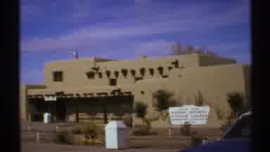 New Mexico (1972): View Of Tan Building And Blue Sky On A Sunny Day