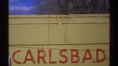 New Mexico (1972): Signage Of Carlsbad New Mexico On A Yellow Building And A Shot