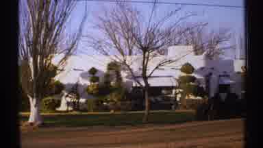 New Mexico (1972): In An Open Countryside Showing Some Trees And Some Buildings