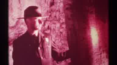 New Mexico (1972): Man Wearing Hat Questioningly Looking Around With Flashlight