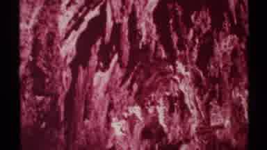 New Mexico (1972): Drone Like View Inside A Pinkish Red Cave With Various