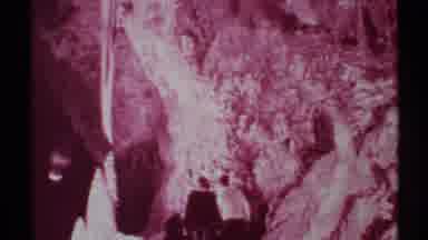 New Mexico (1972): A Few Man Entering In To The Dark And Maroon Color Cave With