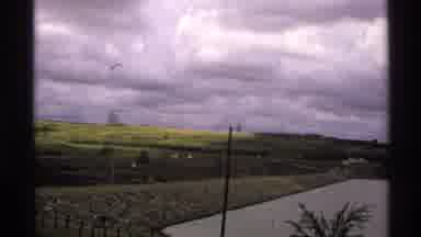 North Dakota (1972): A Pond Houses And A Green Fired Filmed On An Old Camera