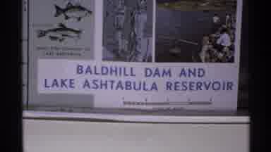 North Dakota (1972): Blue And White Bald Hill Dam Sign And Green Farmland On A