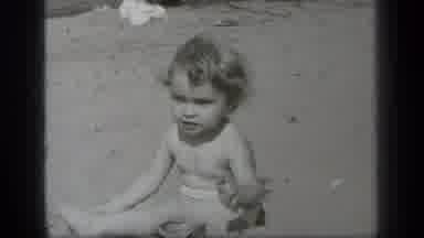 Cleveland Ohio (1938): Baby Playing On The Beach With Sand Scooping It With Small