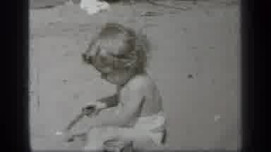 Cleveland Ohio (1938): Toddler Plays In Sand With Toy Spade On A Bright Sunny Day