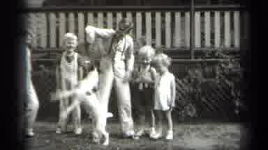 Cleveland Ohio (1938): A Man And Children Enjoy The Dog Playing Inside Park