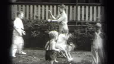 Cleveland Ohio (1938): Children Playing With A Puppy With An Adult Mother Amongst