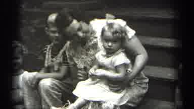 Cleveland Ohio (1938): A Smiling Lady With A Little Girl In Her Lap Sits On The