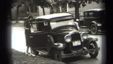 Cleveland Ohio (1938): A Woman In A Knee-Length Dress Getting Into A Car And