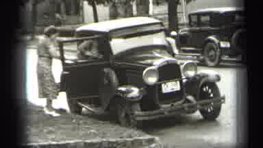 Cleveland Ohio (1938): Two People Getting In A Small Black Car