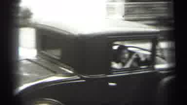 Cleveland Ohio (1938): Woman Wearing Black Dress Waves At Camera As Person Drives