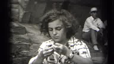 Cleveland Ohio (1938): Boy Tucking Hair Behind Ear Trying To Open Something Near