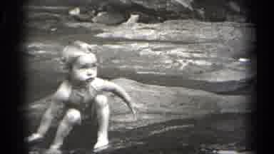 Cleveland Ohio (1938): Young Blond Girl Splashing Water In A Shallow Clear Rocky