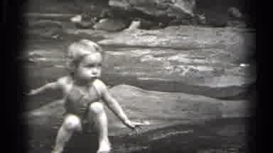 Cleveland Ohio (1938): Child Sits On Rock In A River While Playing With Water